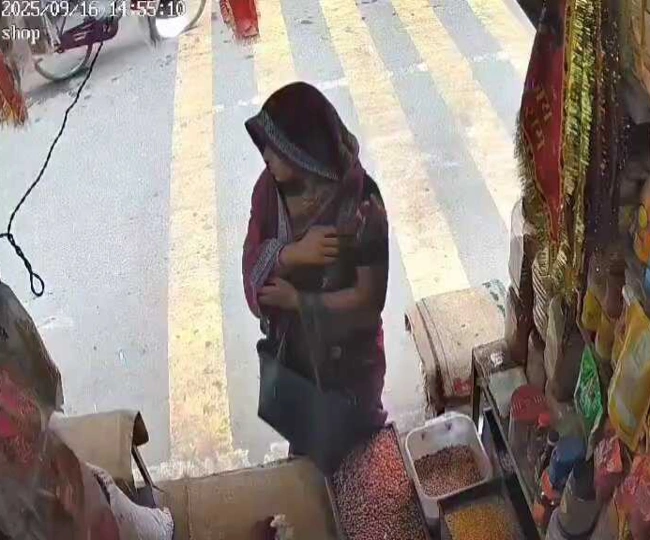 woman stealing cashews from shop