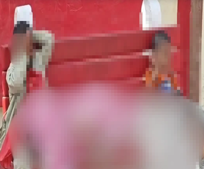Two children cry at railway station holding their dead body of mother in their lap